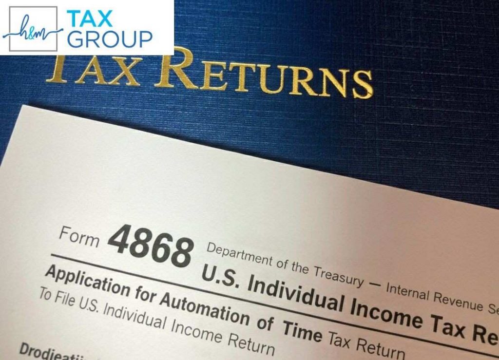 H&M Tax Group professionals assisting clients with tax extension filing, ensuring deadlines are met and penalties avoided