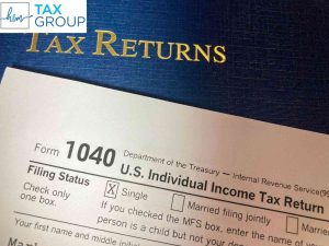 H&M Tax Group professionals assisting clients with tax extension filing, ensuring deadlines are met and penalties avoided